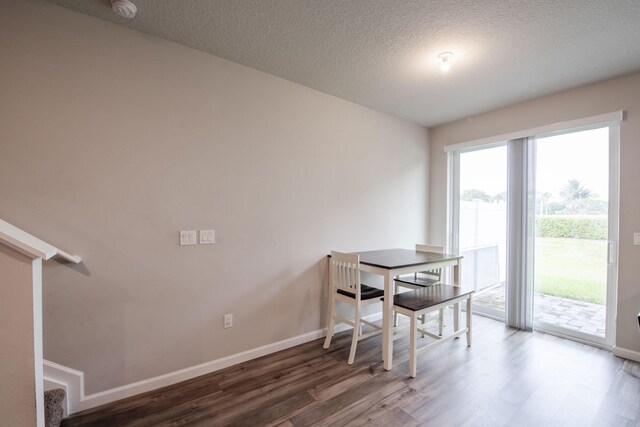 6341 Topsail Dr, West Palm Beach, FL 33413 - dining room featuring wood finished floors, baseboards, a textured ceiling, and stairs