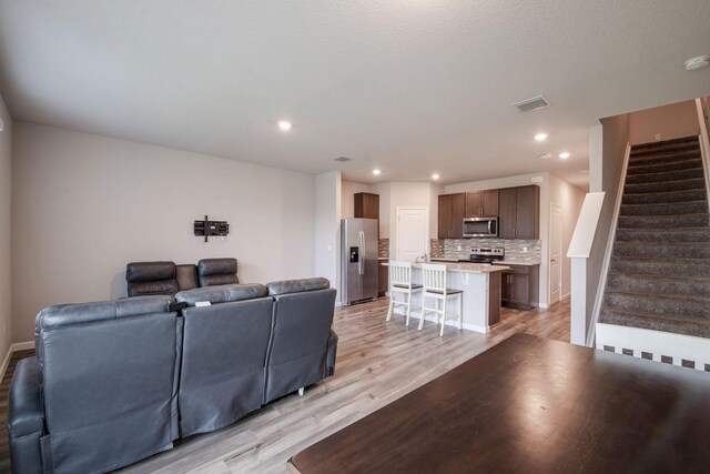 6341 Topsail Dr, West Palm Beach, FL 33413 - living area featuring light wood-style flooring, stairs, recessed lighting, and baseboards