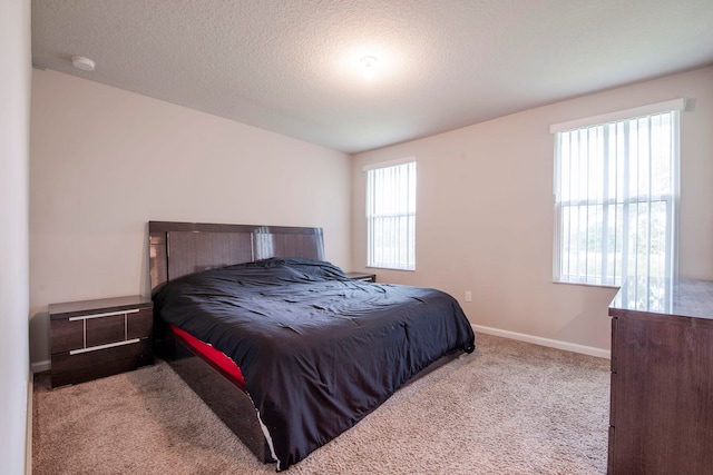 carpeted bedroom with a textured ceiling