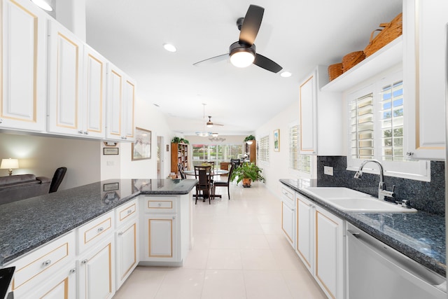 kitchen with kitchen peninsula, white cabinetry, dishwasher, and sink