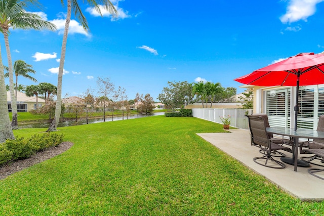 view of yard featuring a patio and a water view