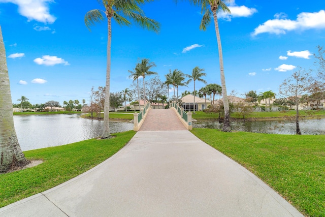 view of home's community featuring a yard and a water view