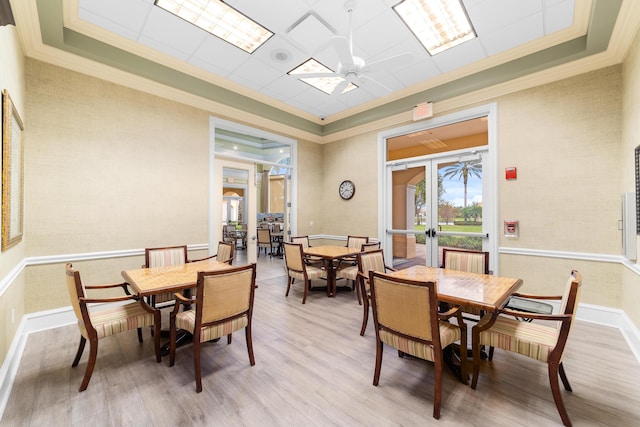 dining area with crown molding, french doors, ceiling fan, and light hardwood / wood-style floors