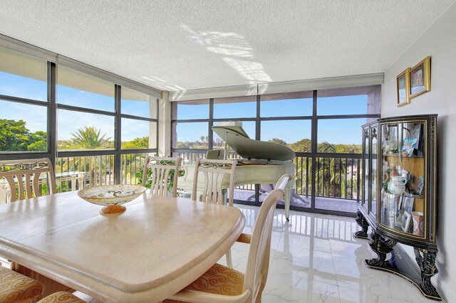 sunroom featuring an inviting chandelier