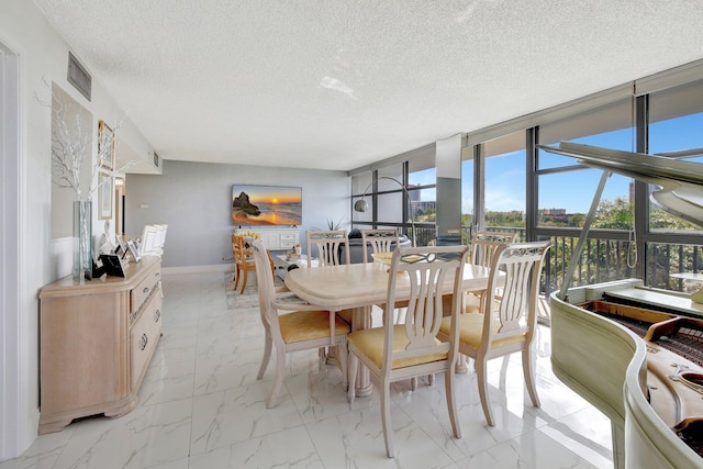 dining room with a wall of windows and a textured ceiling