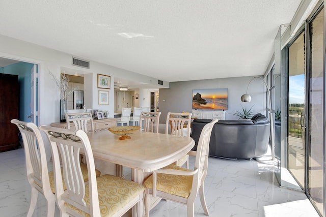 dining area with a textured ceiling