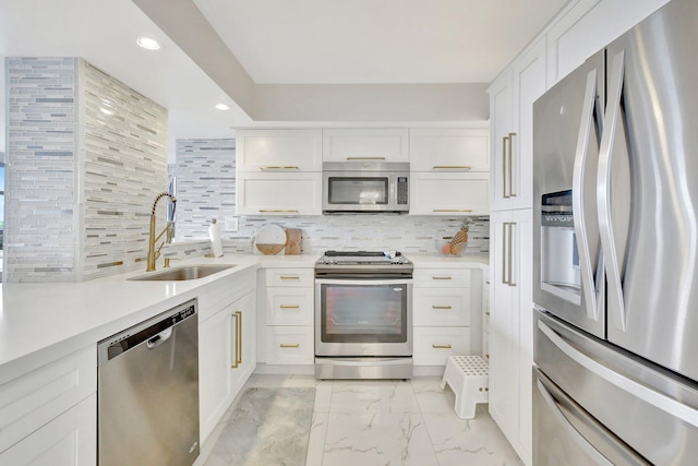 kitchen with white cabinetry, sink, appliances with stainless steel finishes, and tasteful backsplash