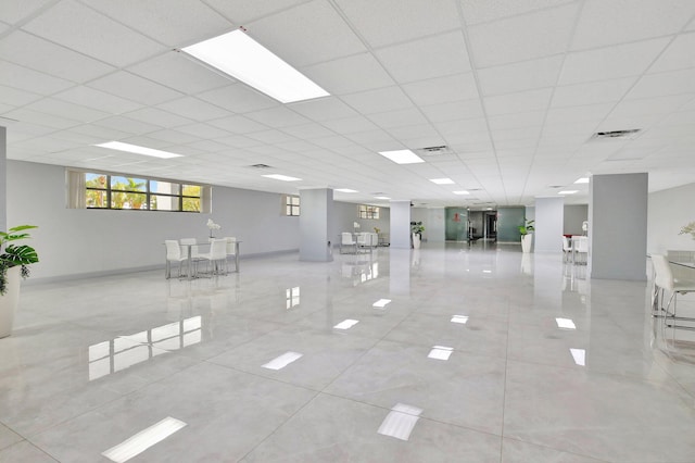 interior space featuring a drop ceiling and light tile patterned flooring