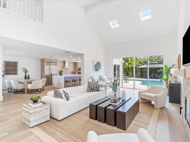 living room featuring light wood-type flooring and high vaulted ceiling