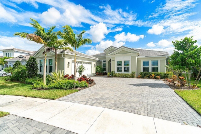 ranch-style home featuring a garage and a front lawn