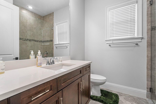 bathroom with toilet, vanity, tile patterned floors, and walk in shower