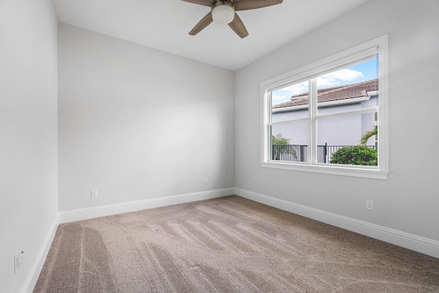 carpeted empty room featuring ceiling fan