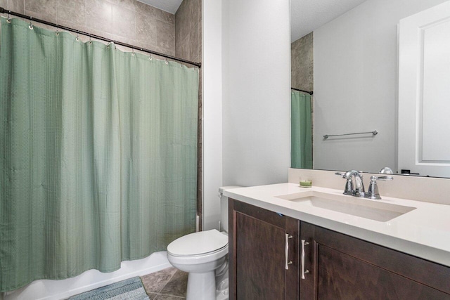 full bathroom featuring toilet, shower / bath combo, vanity, and tile patterned floors