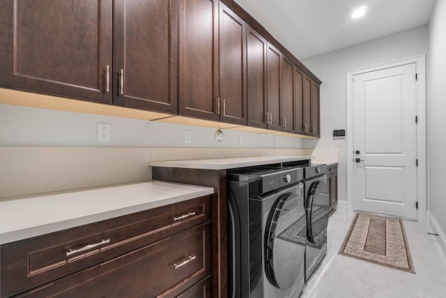 laundry room with cabinets, independent washer and dryer, and light tile patterned floors