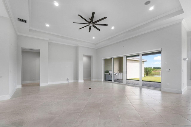 tiled spare room featuring ceiling fan, a raised ceiling, and crown molding