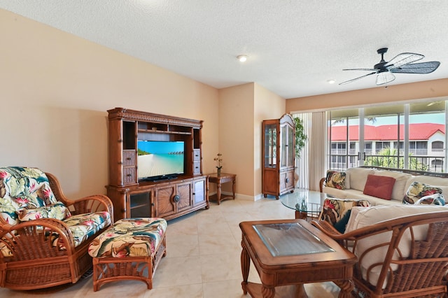 tiled living room with ceiling fan and a textured ceiling