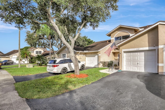 view of front facade featuring a front yard and a garage