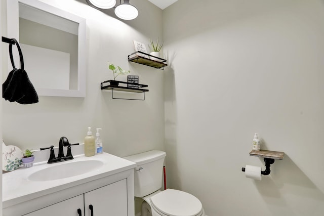 bathroom featuring toilet and vanity