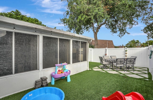 view of yard featuring a patio area and a sunroom