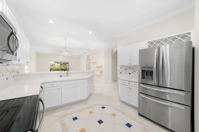 kitchen with sink, decorative backsplash, ornamental molding, white cabinetry, and stainless steel appliances