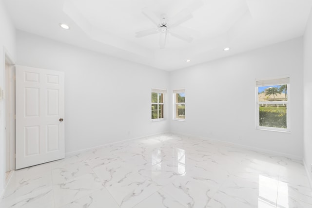 spare room with a wealth of natural light and ceiling fan