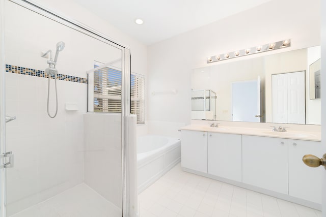 bathroom with tile patterned floors, vanity, and separate shower and tub