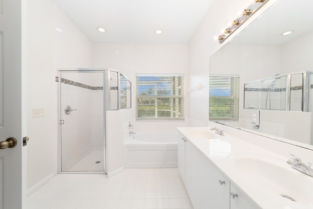 bathroom with tile patterned flooring, vanity, and plus walk in shower