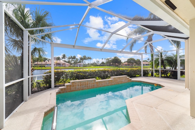 view of pool with a lanai, a patio area, and a water view