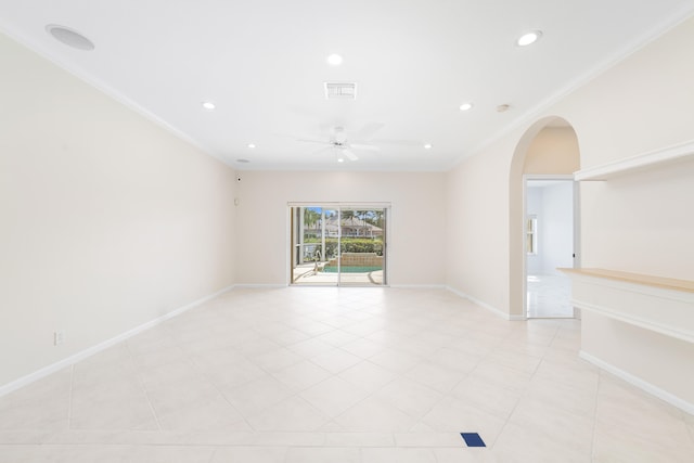 empty room with ceiling fan, ornamental molding, and light tile patterned floors