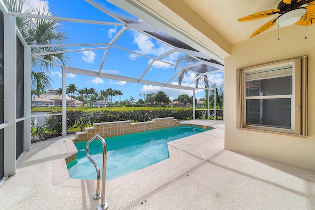 view of swimming pool with a lanai and a patio