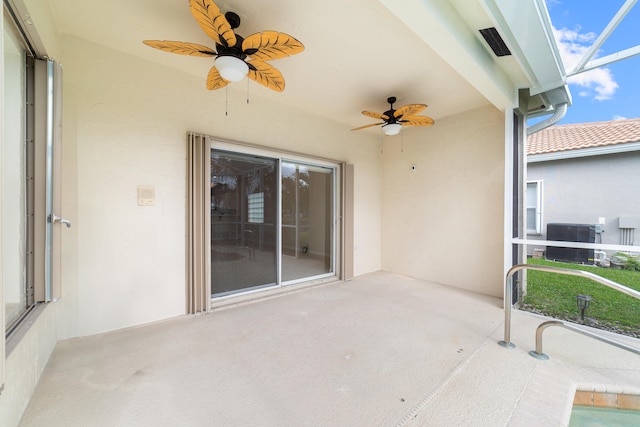 view of patio with ceiling fan and glass enclosure