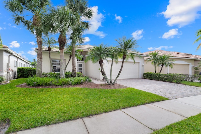 view of front of house with a front yard and a garage