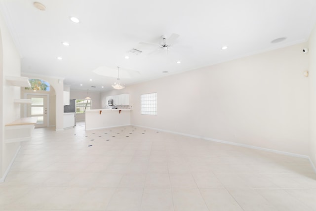 empty room featuring ceiling fan, light tile patterned flooring, and ornamental molding