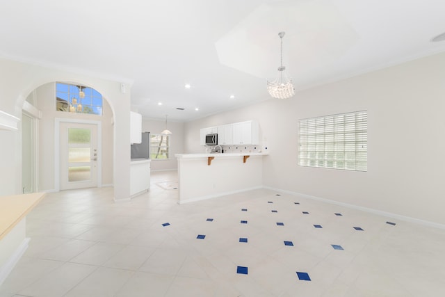 interior space with crown molding, light tile patterned flooring, and a chandelier