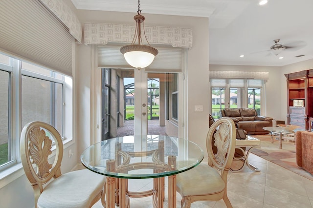 tiled dining room featuring ceiling fan and crown molding