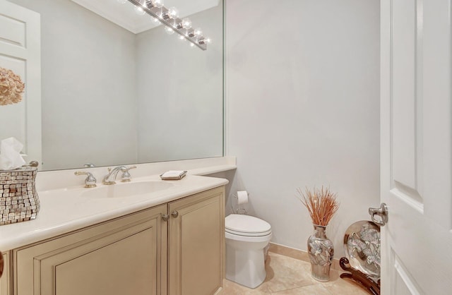 bathroom with tile patterned flooring, vanity, and toilet