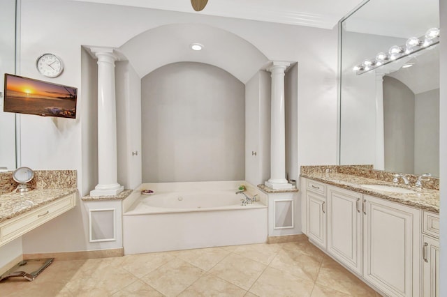 bathroom with tile patterned floors, vanity, and a washtub