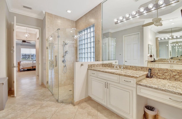 bathroom with tile patterned flooring, a shower with door, ceiling fan, and ornamental molding