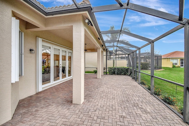 view of patio / terrace featuring glass enclosure and french doors