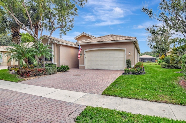 view of front of house featuring a garage and a front lawn