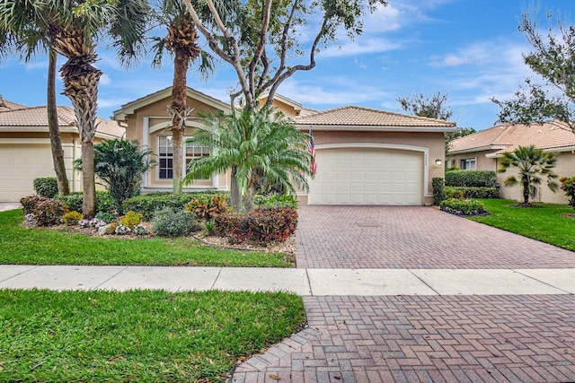 view of front of house with a front yard and a garage