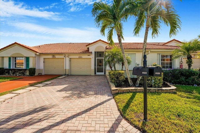 mediterranean / spanish-style home featuring a garage and a front lawn