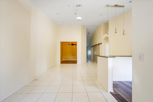 unfurnished room featuring ceiling fan, light tile patterned flooring, and high vaulted ceiling