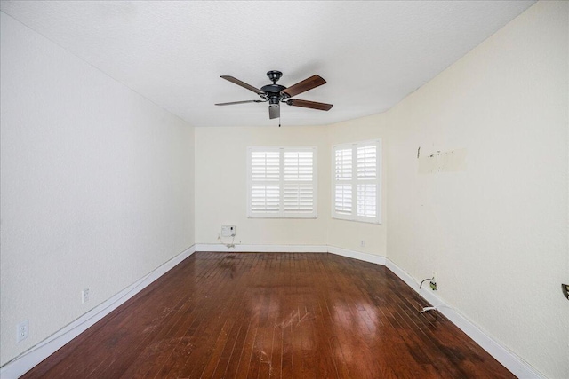 empty room with ceiling fan and dark wood-type flooring