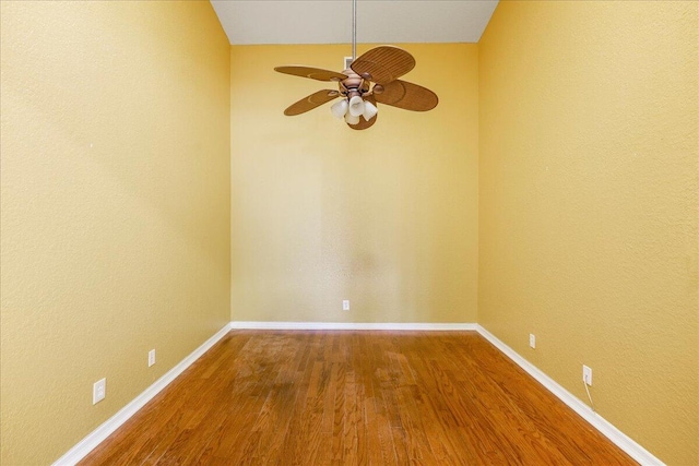 spare room with hardwood / wood-style flooring, ceiling fan, and lofted ceiling