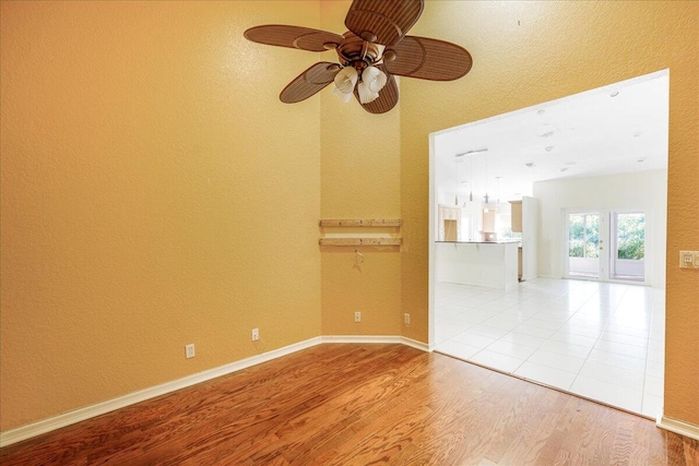 empty room featuring ceiling fan and hardwood / wood-style flooring