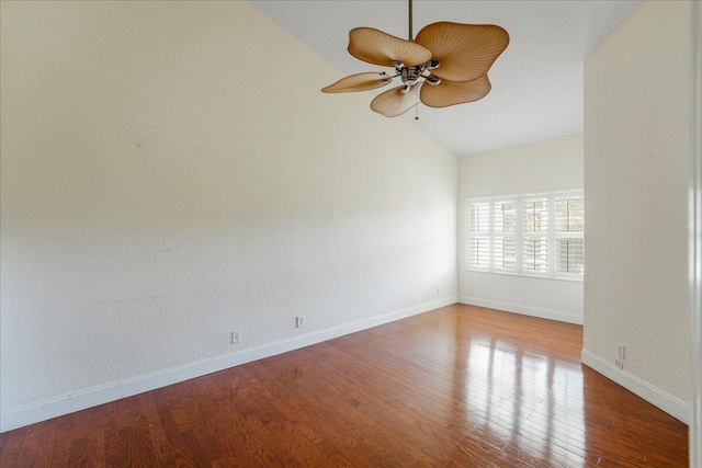 empty room with hardwood / wood-style flooring, vaulted ceiling, and ceiling fan