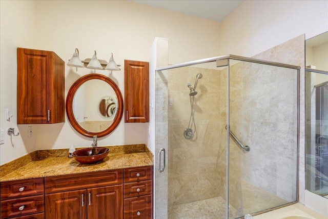 bathroom with vanity and a shower with door