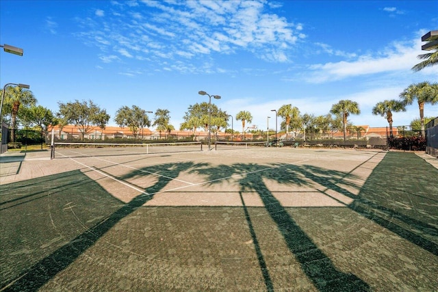 view of community featuring tennis court