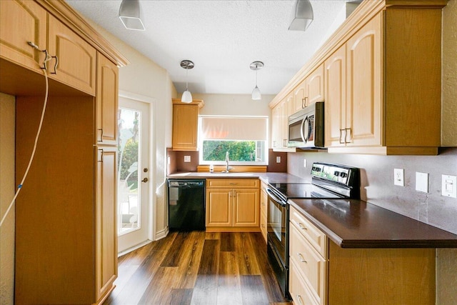 kitchen with pendant lighting, light brown cabinets, dark wood-type flooring, black appliances, and sink